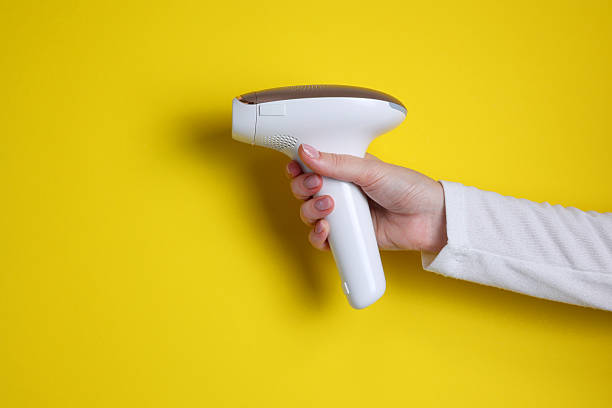istock Modern home photoepilator on a colored background. Remove unwanted hair. 2249551588