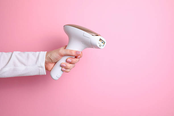 istock Modern home photoepilator on a colored background. Remove unwanted hair. 2249551605