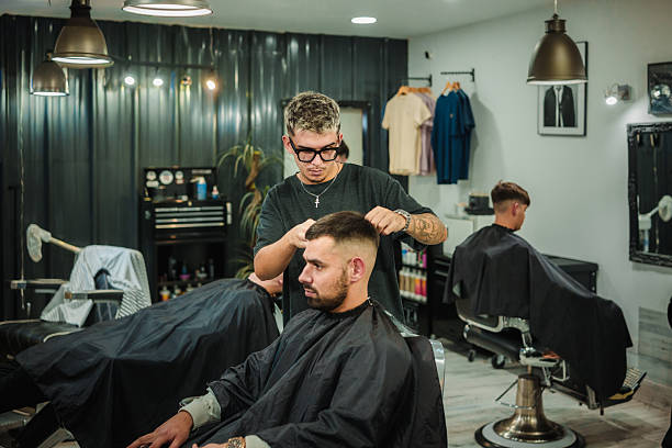 istock Barber cutting client's hair in modern barbershop 2249551831