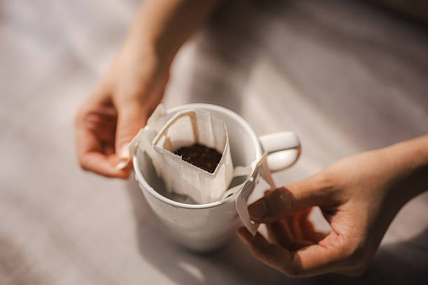 Drip coffee in glass cup on wooden table