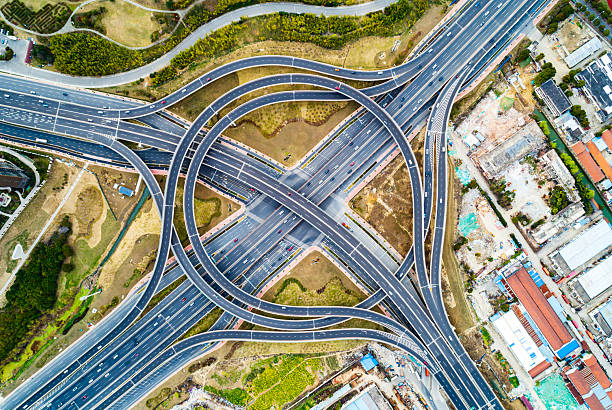 istock Aerial view of complex highway interchange surrounding lush greenery in daylight 2249555077