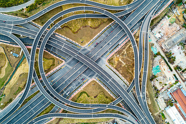 istock Aerial view of complex highway interchange surrounding lush greenery in daylight 2249555334