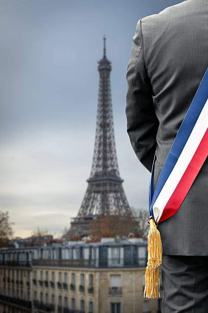 istock A mayor seen from behind wearing his mayoral sash with the Eiffel Tower in the background 2249555384