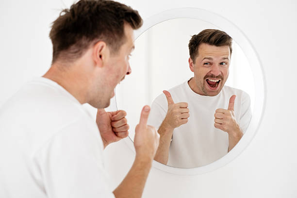 istock young man trying to cheer himself up before a first date 2249556916