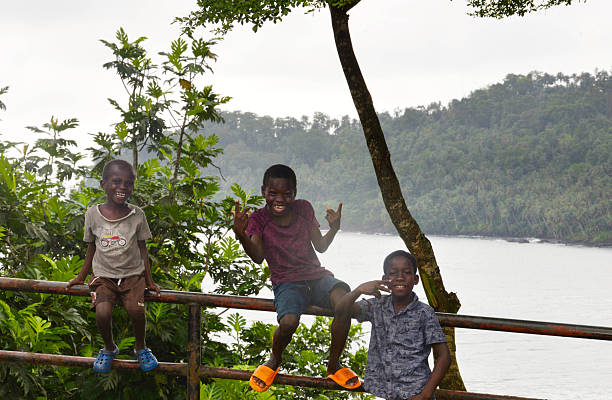 Hoima, Uganda - November 18, 2011: African kids - Groups of children different age are running and playing against the camera on the grasses at small village.