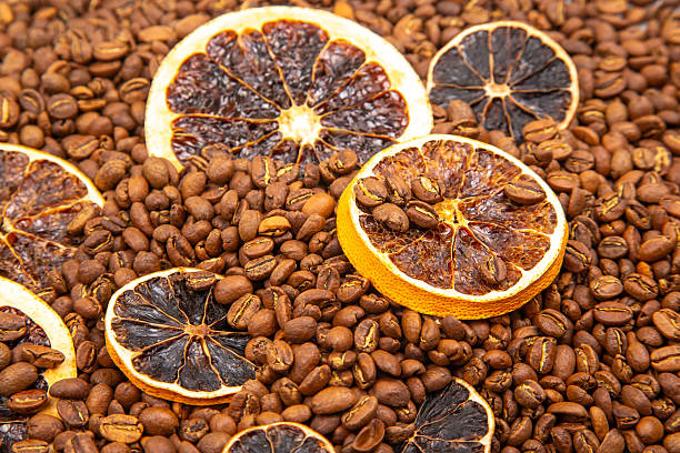 istock Warm and inviting image of dried citrus slices mingled with roasted coffee beans, capturing a rustic and aromatic essence. coffee aroma and taste descriptors 2249559533