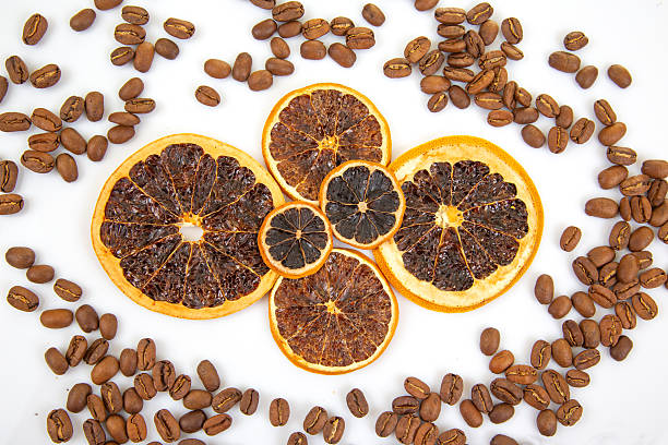 istock dried orange slices with bold coloration, paired with roasted coffee beans on a white surface. Excellent for food photography, wellness products, or exotic flavor promotions. 2249559696