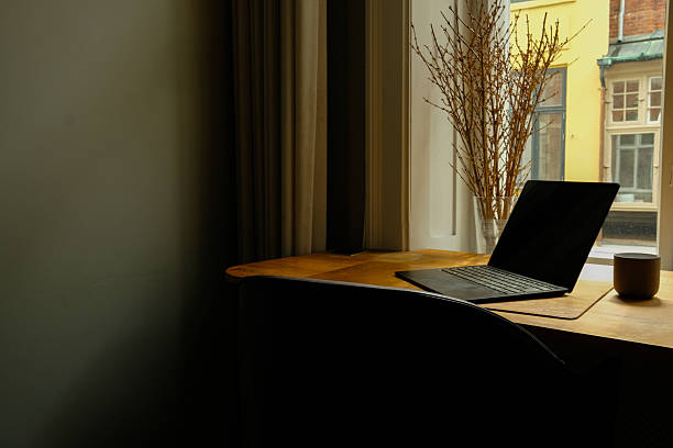 istock Minimalist Home Office Workspace with Laptop by Sunlit Window 2249561719