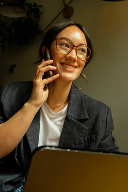 istock Asian Businesswoman Using Smartphone in Modern Workspace – Natural Light Portrait 2249561815