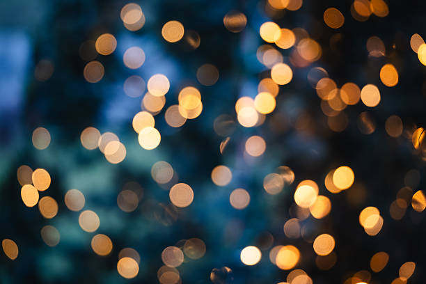 istock Golden christmas lights bokeh on dark tree 2249562194
