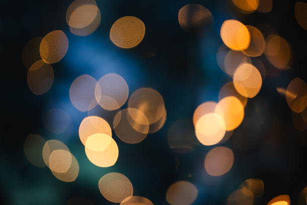 istock Golden christmas bokeh lights on blue background 2249562196