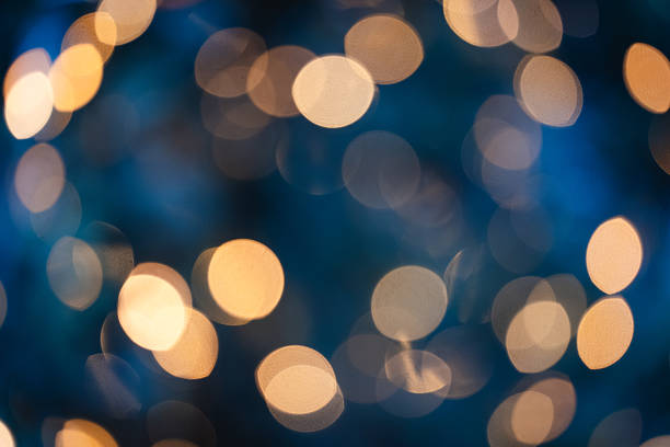 istock Golden christmas bokeh lights on blue background 2249562215