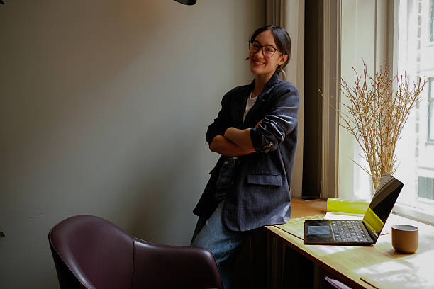 istock Asian Businesswoman Using Smartphone in Modern Workspace – Natural Light Portrait 2249562319