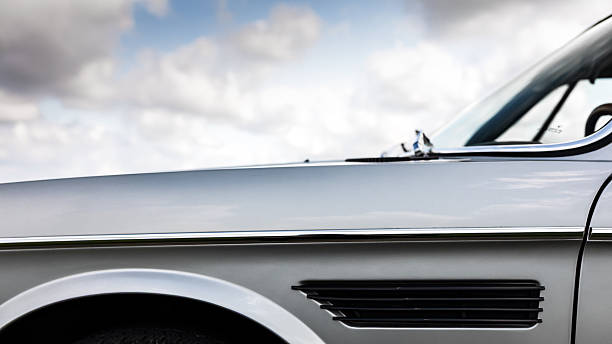 istock Front Fender Detail of Classic Silver Coupe under Cloudy Sky 2249562615
