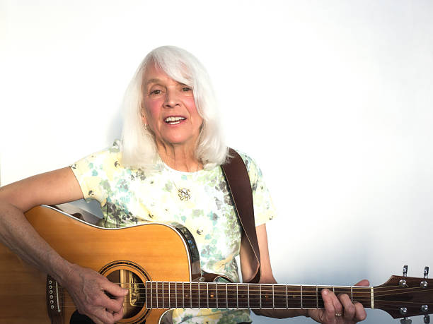 Woman Playing Folk Guitar (Close-Up). Copy space available.