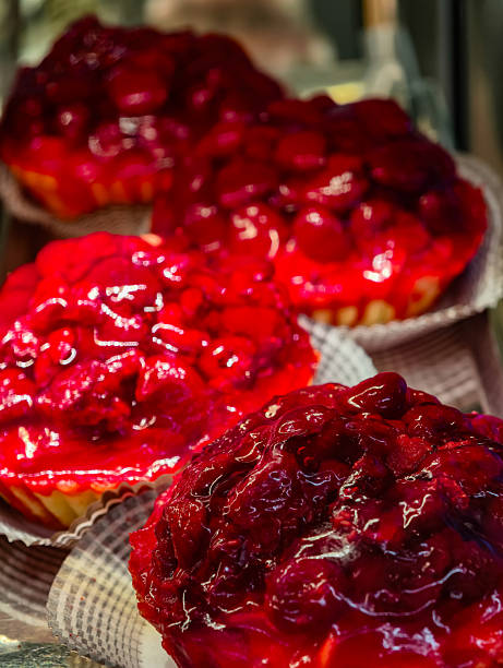 istock Fresh Strawberry Glazed Fruit Tarts with Shiny Red Berry Topping Display at Artisan Bakery. Food Background 2249564355