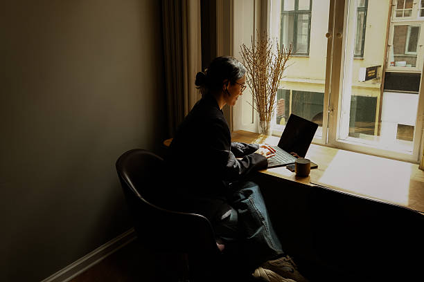istock Asian Businesswoman Using Smartphone in Modern Workspace – Natural Light Portrait 2249565192