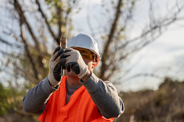 istock Geologist in a quarry, searching for minerals, showing a citrine quartz crystal in an open pit. 2249566331