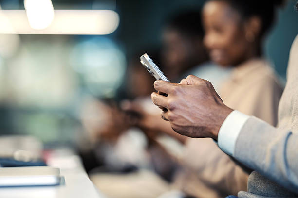istock Black adult using smartphone in a modern office 2249566925