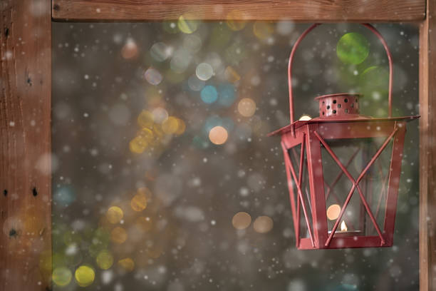 small red lantern with bokeh and snow