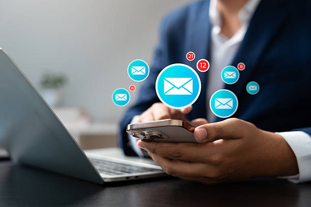 istock New message notification concept, Businessman checking new email notifications on smartphone with digital icons, representing online communication, instant messaging, and modern workspace connectivity 2249568999