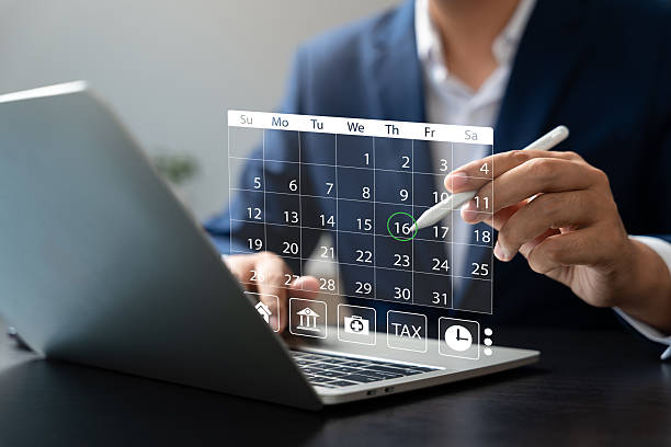 istock Businessman managing schedule with digital calendar interface on laptop using stylus pen, representing time management, event planning, productivity, and online appointments. 2249569601
