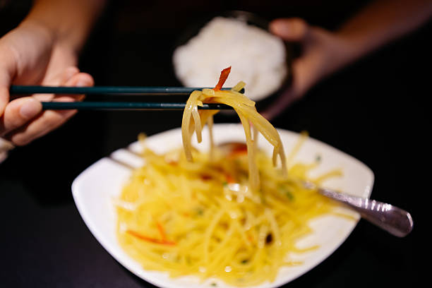 Close-up of a Chinese stir-fried potato dish made with thinly sliced potatoes, commonly served as a home-cooked meal or side dish in China.