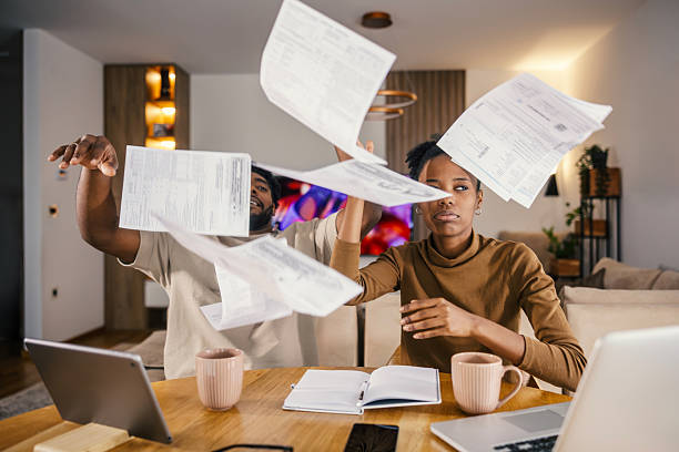 istock Couple throwing financial bills because of money problems 2249572280