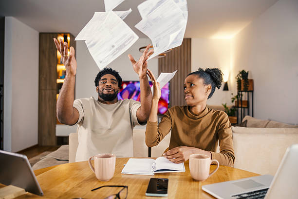 istock Couple throwing financial paperwork feeling stressed about budget 2249572282