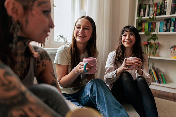 istock Three Friends Laughing and Drinking Coffee at Home 2249573434