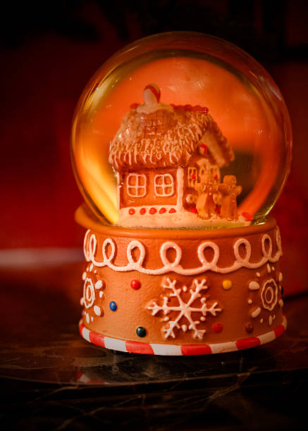 Christmas Gingerbread house snow globe in an English manor house.