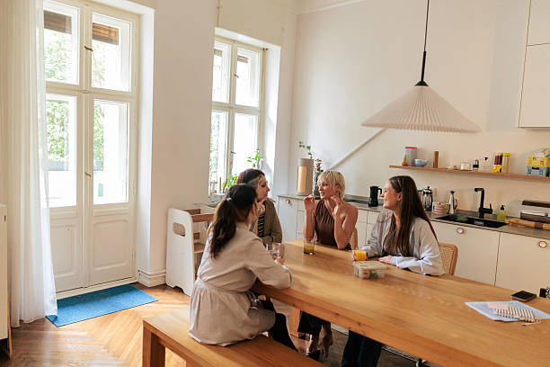 istock Group of Friends Talking and Enjoying Coffee in a Bright Kitchen 2249573686