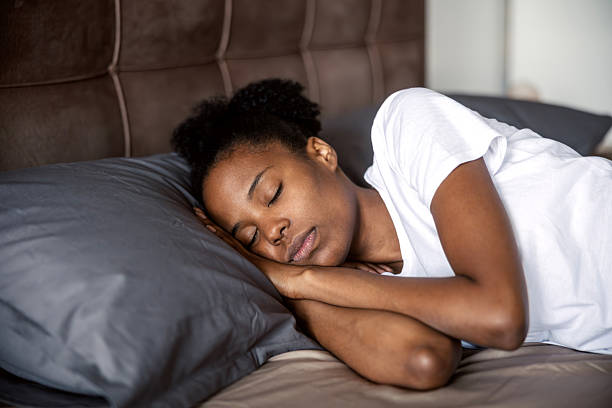 istock Young black woman peacefully sleeping in bed 2249573718