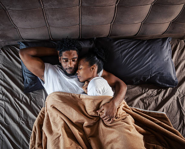 istock African american couple sleeping embracing in bed 2249573805