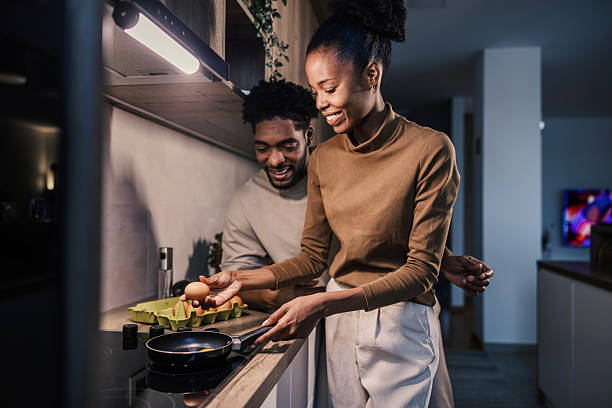 istock Young black couple cooking breakfast in modern kitchen 2249574956