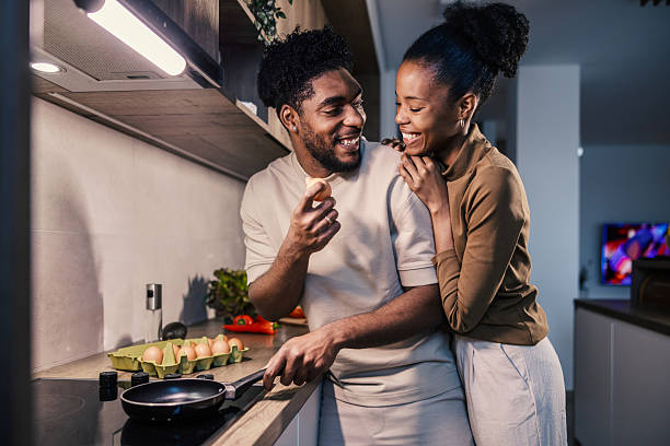 istock Happy couple cooking breakfast together in kitchen 2249574995