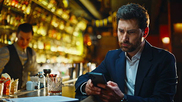istock Frustrated guy holding smartphone in cafe bar closeup. Heartbroken man texting 2249575417