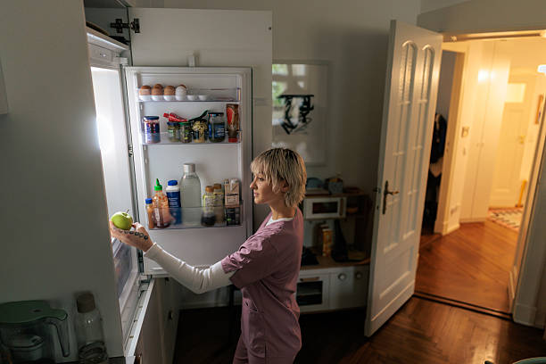 istock Nurse Taking a Snack From the Refrigerator 2249575569