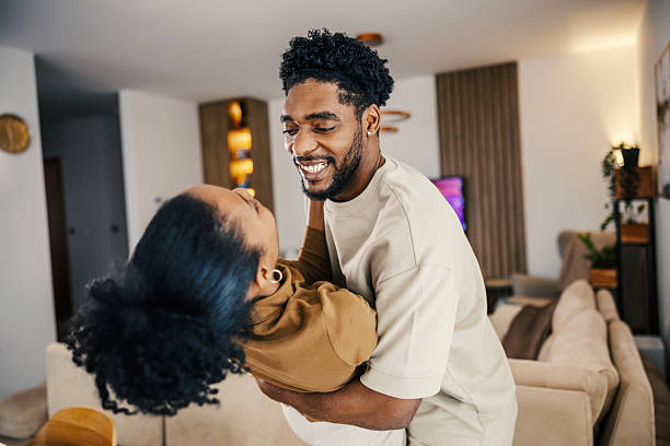 istock Happy black couple dancing together in living room 2249575708
