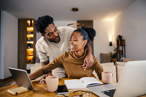 istock Couple collaborating on laptop in modern home 2249575734