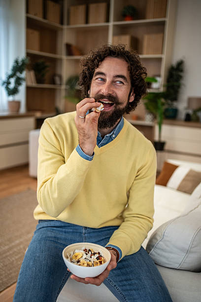 istock Man enjoying healthy breakfast bowl in modern home 2249576831