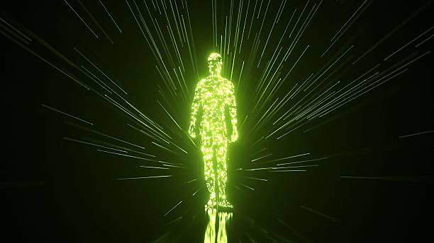 istock Green luminous particles coalescing to form a human silhouette, which then stands while radiating brilliant light rays against a dark background, conceptualizing creation and digital consciousness 2249578149