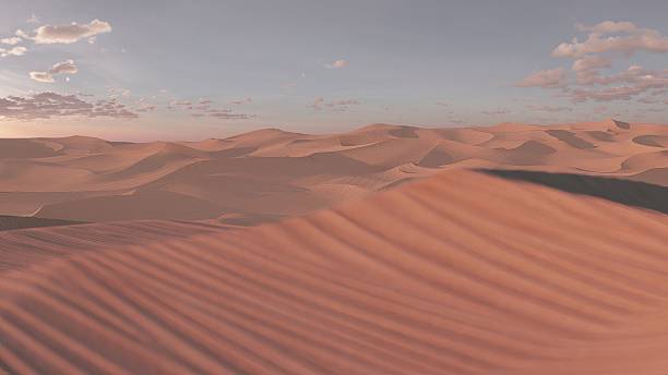 istock Warm sunlight illuminates rippling sand dunes in a vast desert landscape, creating a serene and captivating scene as the sun sets below the horizon 2249578156