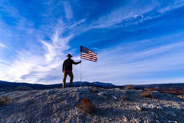 istock Cowboy on Ridge with American Flag 2249578177