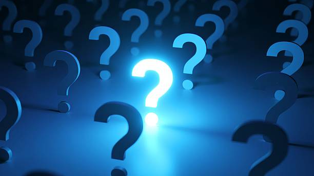 istock Bright, glowing question mark standing out in a crowd of dark question marks, representing a brilliant idea, solution, or answer to a problem in a conceptual blue illuminated environment 2249578183
