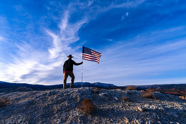 istock Cowboy on Ridge with American Flag 2249578247