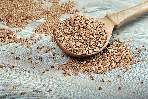 istock Buckwheat seeds on wooden spoon. close up. 2249580259