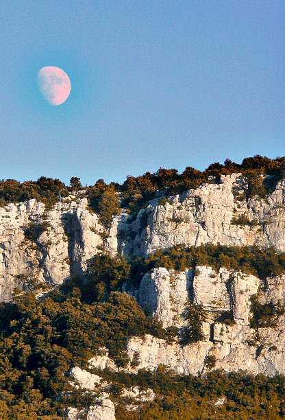 The moon stands out against a blue sky