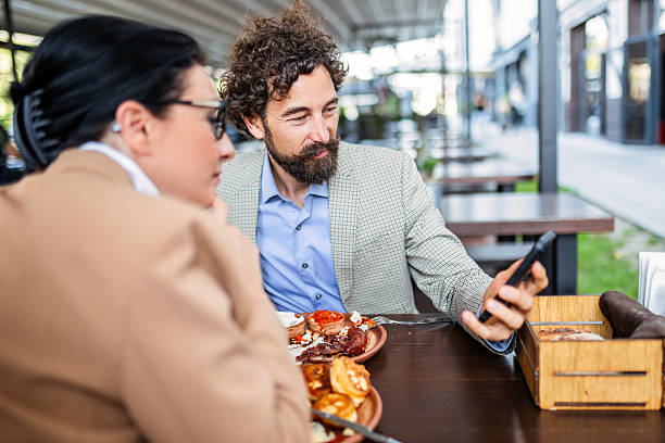 istock Business Colleagues Sharing Ideas Over a Meal in Restaurant 2249580636