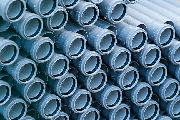 istock Stacked PVC pipes with water droplets ready for installation at construction or plumbing site 2249583206